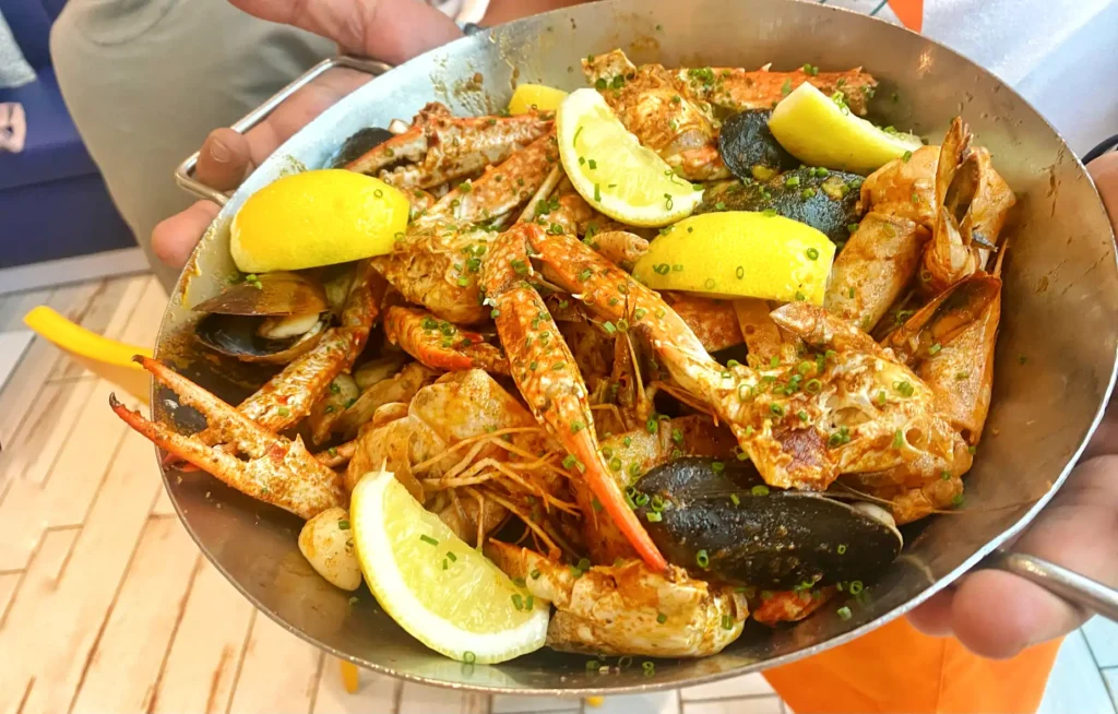 A large bowl contains seafood, shellfish, crab, and lobster.