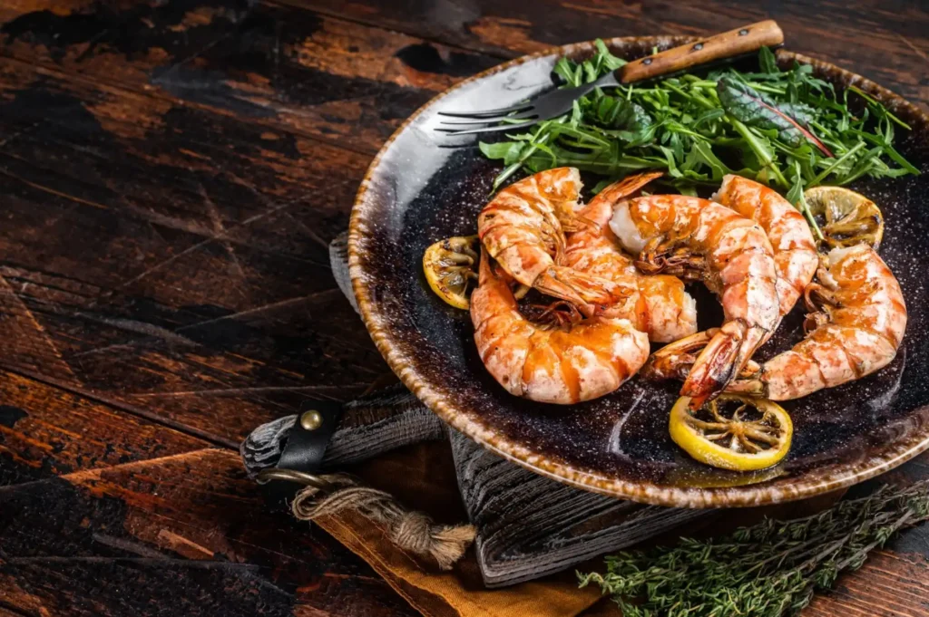 Shrimp in a bowl on a wooden table.