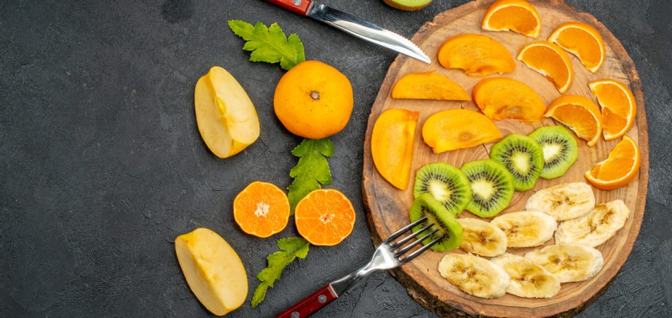 A fruit platter with oranges, mango, kiwi, pears, and figs