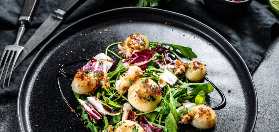 Grilled scallops served over microgreens.