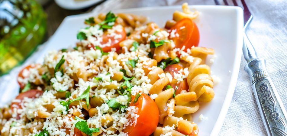 A tomato and feta pasta dish with garlic butter sauce.